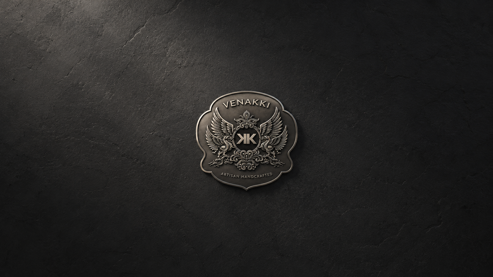 VENAKKI coat of arms mounted on a dark charcoal stone wall